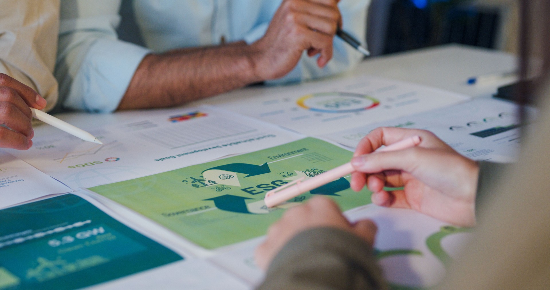 Closeup Asia businesspeople talk ESG strategies risk management workshop night, SDGs, global warming, green finance and investment and net zero waste lifestyle in boardroom training building.