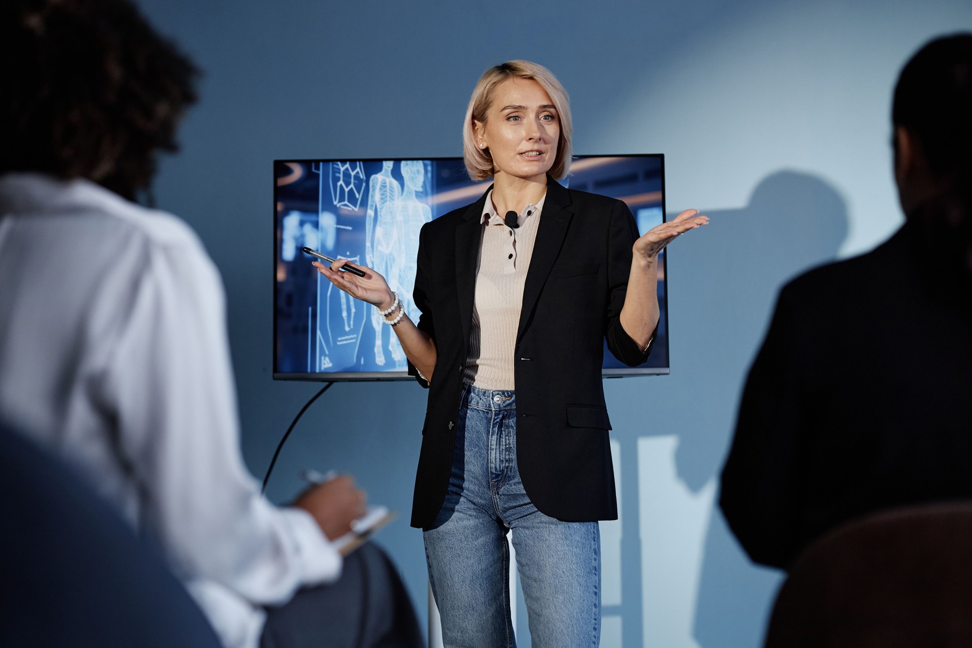 Female Speaker Leading Talk on Using AI in Business in Auditorium